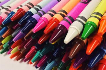 Colour photo of different coloured crayons laying on their side