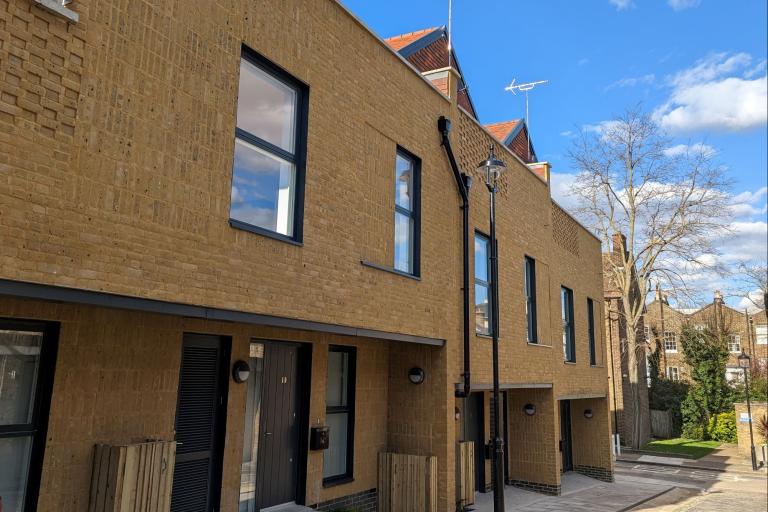 The front of the new homes at Ordnance Mews on a sunny, blue sky day
