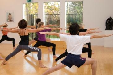 People practicing yoga in studio