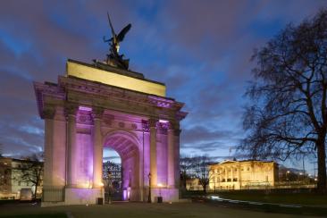 Wellington Arch at night, lit up with purple lighting