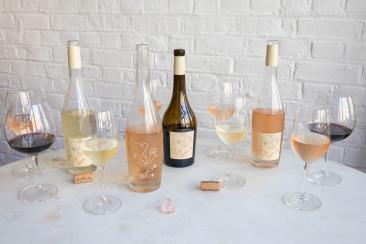 Amie Wine studio bottles & glasses of wine on a table