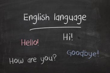 Colour image of chalkboard with text: hello, hi, how are you and goodbye written in chalk