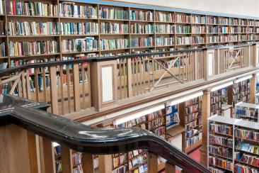 Photo of the inside of a library with bookcases