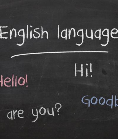 Colour image of chalkboard with text: hello, hi, how are you and goodbye written in chalk