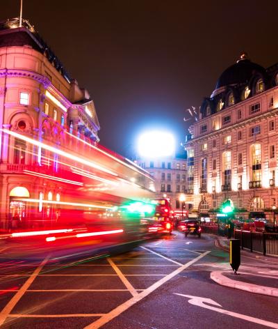 The blur from the lights of a bus going up Regent Street at night time