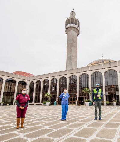Four healthcare workers standing outside the London Central Mosque