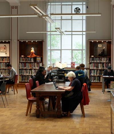 People working at desks in a large communal area in the Westminster Reference Library