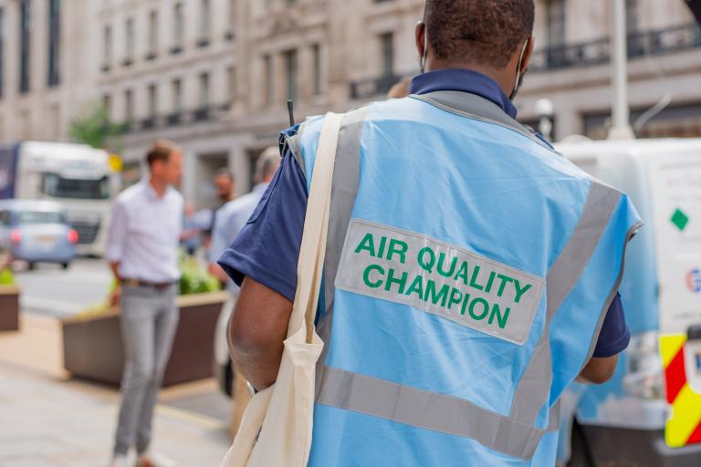 An air quality champion wearing a blue polo and a blue hi-vis jacket