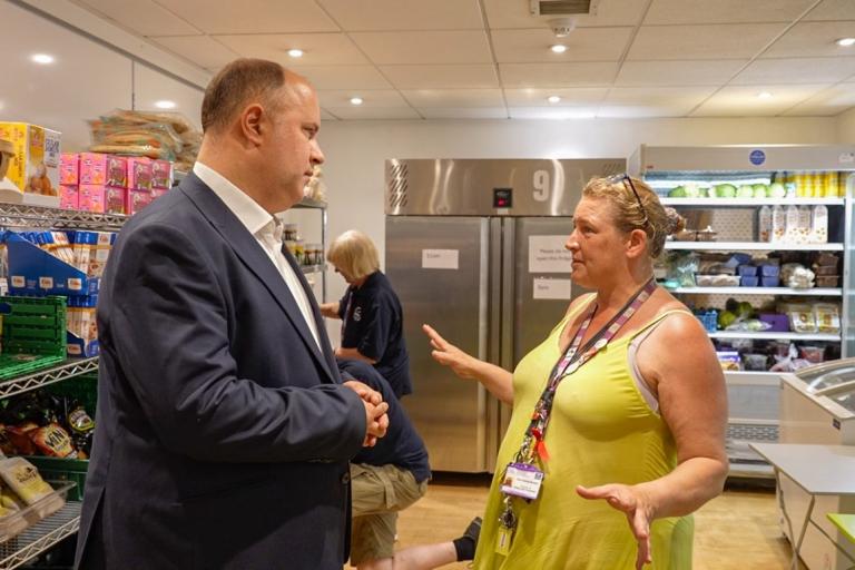 The Leader Cllr Adam Hug speaking to a volunteer at the Food Pantry in the Abbey Centre