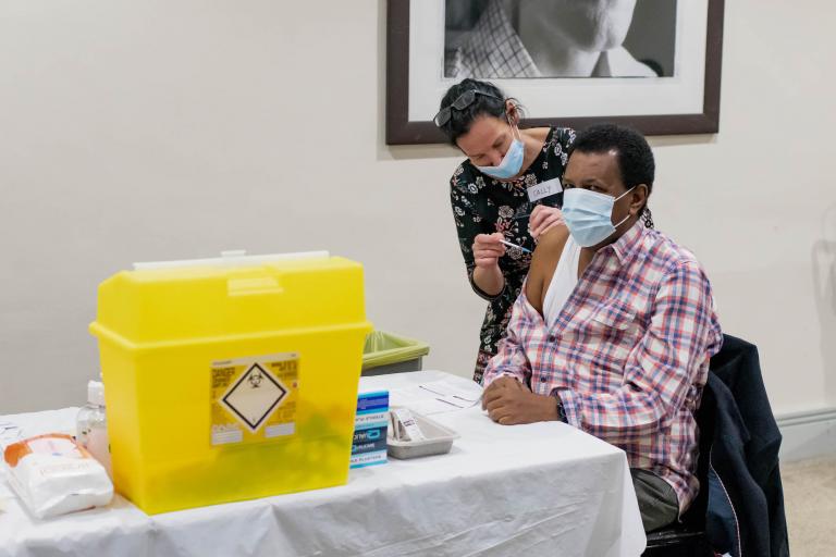Image of a man receiving the covid-19 vaccine