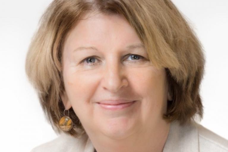 A headshot of Karen Buck MP, smiling at the camera