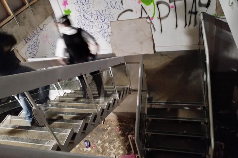 Police officers walking down stairs in a premises once used for illegal raves