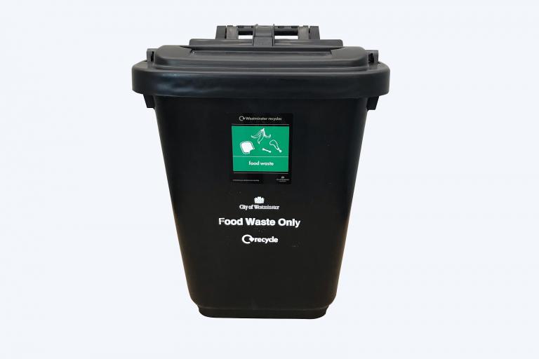 A small black outdoor food waste bin