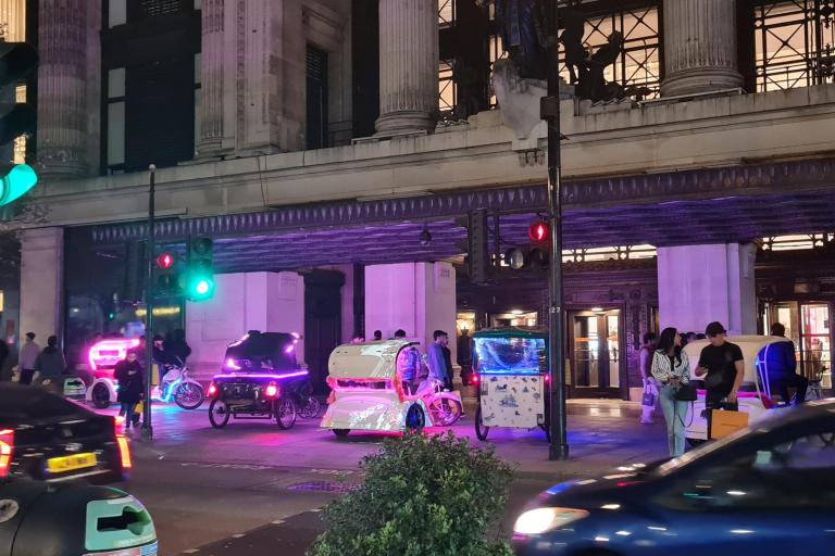 A line of pedicabs waiting outside Selfridges Department Store on Oxford Street