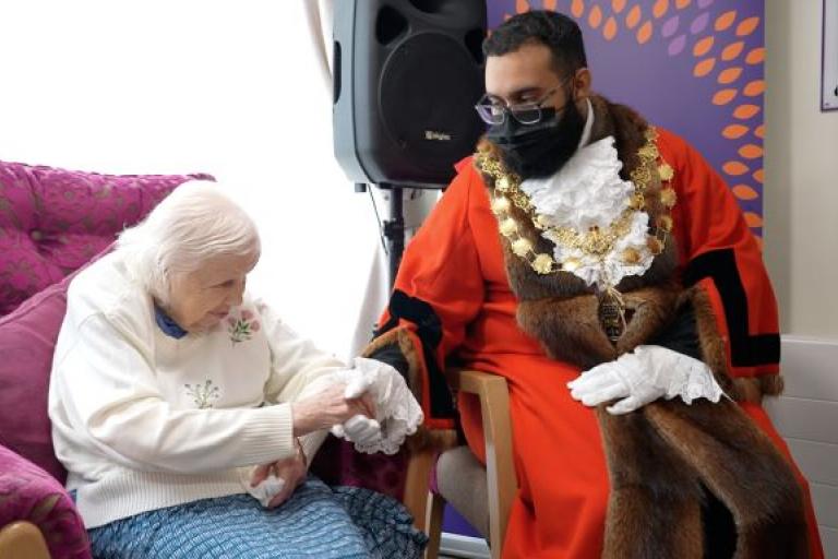 The lord mayor speaking to a resident in a care home