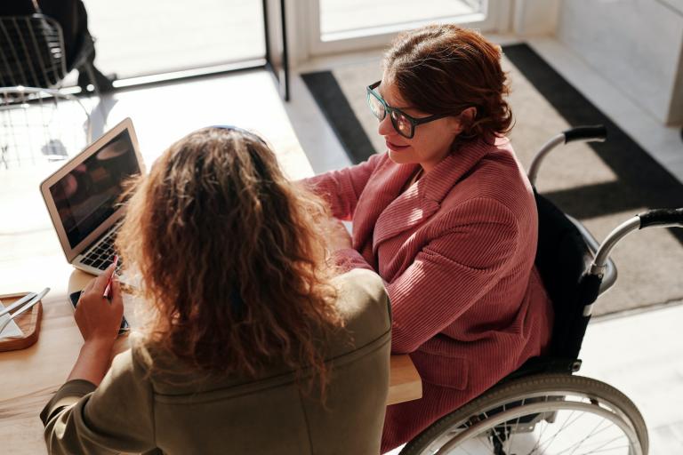 Woman in a wheelchair having a one to one meeting with another woman.jpg