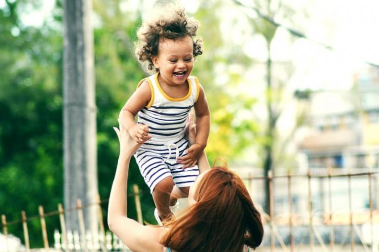 Woman lifting a happy child