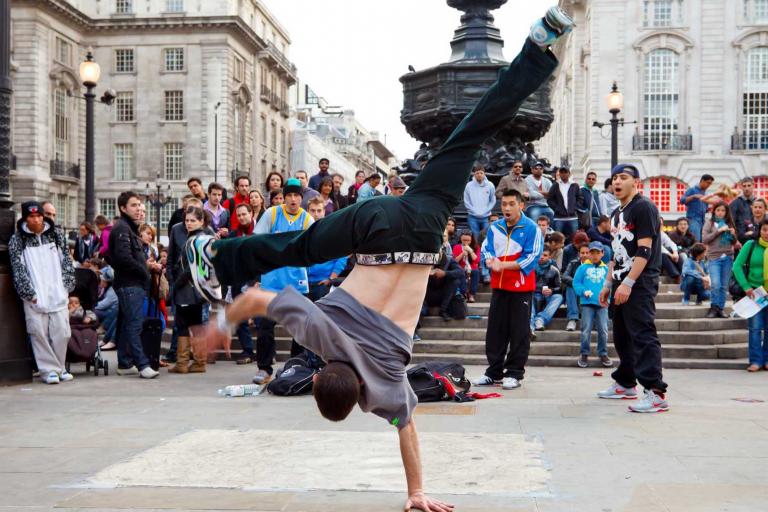 image of a man breakdancing in front of a crowd