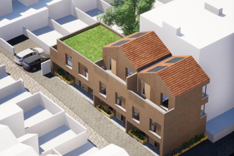 A computer generated image of the proposed new homes at Ordnance Mews showing a three story building and a roof top terrace on one end of the building