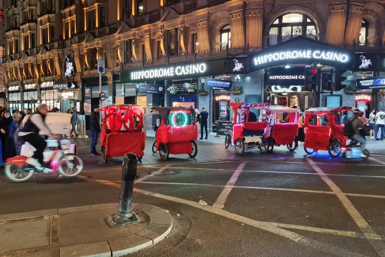 A line of unlicensed red pedicabs lined up outside the Hippodrome Casino