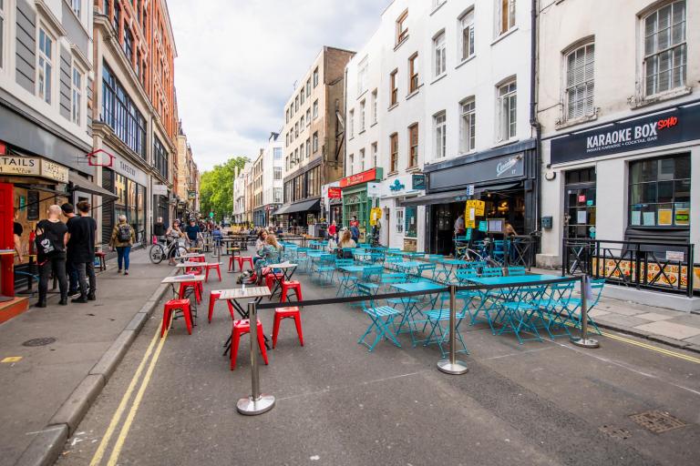 Tables and chairs laid out in soho for al fresco dining