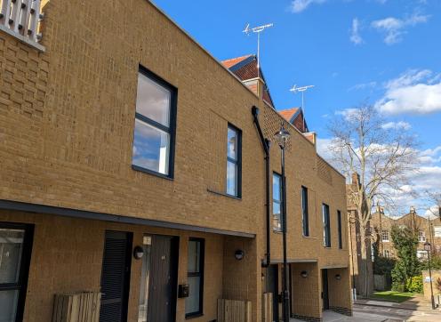 The front of the new homes at Ordnance Mews on a sunny, blue sky day