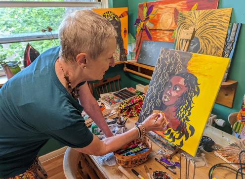 Westbourne artist Jennifer Huie working on a painting at her home studio
